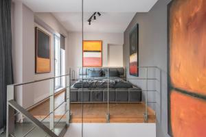 a bedroom with a bed on a glass wall at Artsy Urban Loft in Athens in Athens
