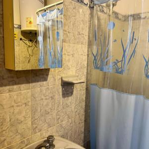 a bathroom with a shower curtain and a sink at Las Dulcineas in La Paloma