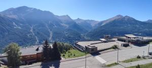 an aerial view of a building with mountains in the background at Au bon endroit N3 - Appartement 2 pièces 5/7 personnes - proche pistes - Belle vue montagne in Orcières