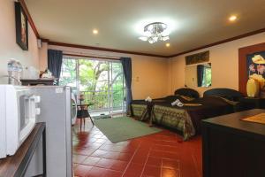 a room with a kitchen and a living room at The Phen House in Hua Hin