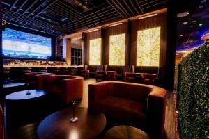 a bar with leather chairs and a large screen at Miccosukee Casino & Resort in Miami