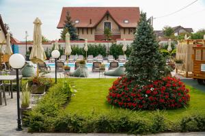 a christmas tree in the middle of a garden at Paleus Resort in Oradea