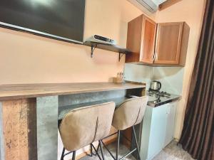 a small kitchen with two chairs at a counter at Apartment Centar in Podgorica