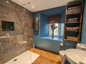 a bathroom with a shower and a sink and a toilet at Chateau De Montmagner in Arnac-la-Poste +103 photos