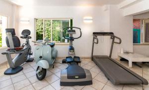 a fitness room with a scooter and exercise equipment at Hotel Euromar in Marina di Massa