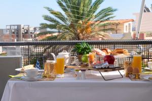 - une table avec petit-déjeuner sur un balcon avec un palmier dans l'établissement Maria's Double Room, à Spáta