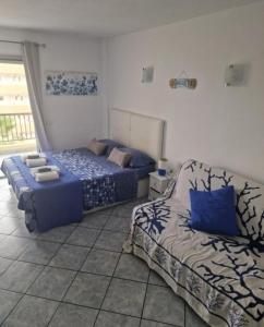 a bedroom with two beds in a room at Eldorado VIVIAN-STUDIO FREE WIFI in Playa de las Americas