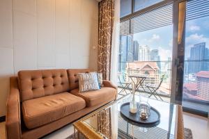 a living room with a couch and a large window at Dorsett Residence Kuala Lumpur 帝盛公寓 Bukit Bintang in Kuala Lumpur