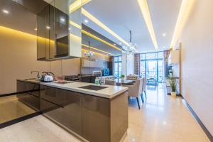 a kitchen with stainless steel appliances and a dining room at Dorsett Residence Kuala Lumpur 帝盛公寓 Bukit Bintang in Kuala Lumpur