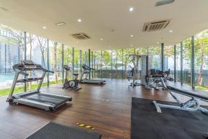 a gym with several treadmills and elliptical machines at Dorsett Residence Kuala Lumpur 帝盛公寓 Bukit Bintang in Kuala Lumpur