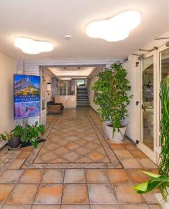 an empty hallway with potted plants in a building at Hotel Euromar in Marina di Massa