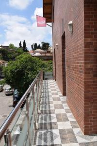 a stairway with a flag on a brick building at Ghazalle oasis Hotel GB in El Biar