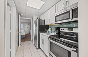 a kitchen with a stove and a refrigerator at Camelot By The Sea 1206 in Myrtle Beach