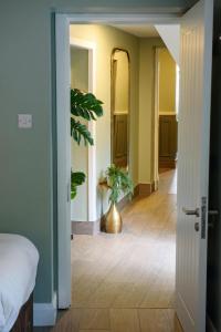 a room with a bed and a vase with a plant at Shannon Bridge House in Carrick on Shannon