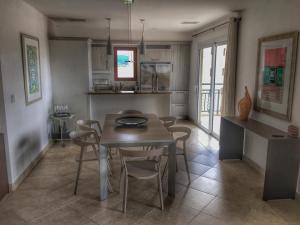 a kitchen and dining room with a table and chairs at Superb 3-Bed Designer Apartment in Cupecoy