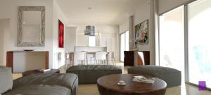 a living room with a couch and a table at Superb 3-Bed Designer Apartment in Cupecoy