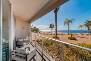 a balcony with chairs and a view of the ocean at Royal Sea View III in Funchal
