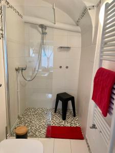 a bathroom with a shower and a stool in it at Sweet Mountain Home in Bad Bleiberg