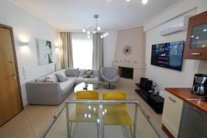 a living room with a couch and a table at Garden Apartment next to the Mall -Private Parking in Athens