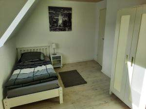 a small bedroom with a bed in a attic at Ferienhaus Hinz in Lohe-Rickelshof