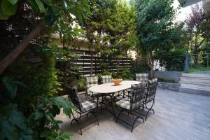 a table and chairs sitting on a patio at Garden Apartment next to the Mall -Private Parking in Athens