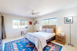 a bedroom with a bed and two windows at Sabino Canyon Hideaway in Tucson