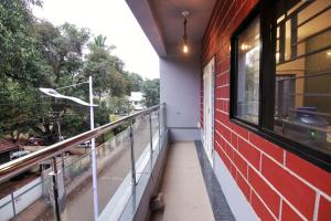 a balcony of a building with a window at Picaddle Serviced Apartment in Belgaum