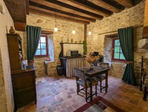 a living room with a table and a fireplace at Chateau De Montmagner in Arnac-la-Poste