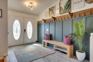 a hallway with a bench and a potted plant at Spacious Colorado Springs Home with Fire Pit! in Colorado Springs