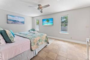 a bedroom with a bed and a ceiling fan at Saltwater Oasis - Large Pool in Jacksonville Beach +56 photos