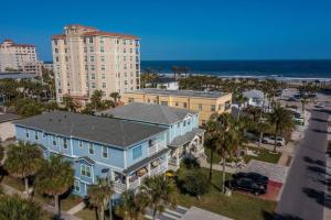 una casa azul con palmeras frente a un edificio en Ocean views, Elevator, Game Room, Two balconies, en Jacksonville Beach