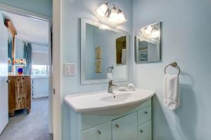 a bathroom with a sink and a mirror at Golf Front - Sawgrass Gate Community in Ponte Vedra Beach
