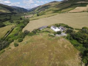 an aerial view of a house on a hill at Snowdonia Hideaway in Tywyn