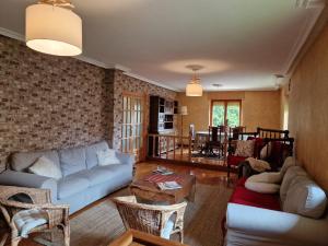 a living room with a couch and a table at Los Kukos Casa Rural in Riaño