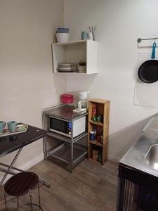a small kitchen with a table and a microwave at Studio Perpignan in Perpignan
