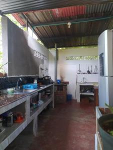 a large kitchen with a sink and a stove at Casa de Campo El Regalo in Norcasia
