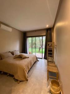 a bedroom with a large bed and a ladder at Le Figuier du Lac Bin elouidane in Bine el Ouidane