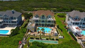an aerial view of a large house with a swimming pool at PI209, Ritz Palm- Oceanfront, 9 BRs, LUXURY, ELEV, Pool, Rec Rm, Theater Rm, Prv Bch wwy in Sanderling