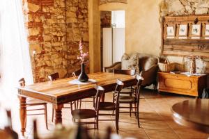 a dining room with a wooden table and chairs at Dimora Buglioni Wine Relais in San Pietro in Cariano
