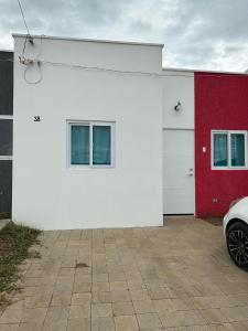 a white and red garage with a car parked next to it at Casa Amueblada en Santa Ana in Santa Ana