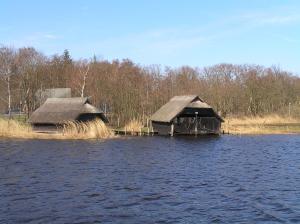 two houses in the middle of a body of water at Eichenblick in Prerow