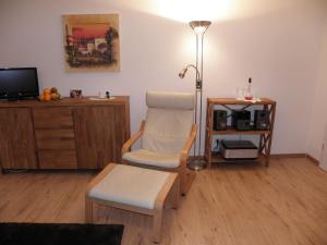 a living room with a chair and a table at Eichenblick in Prerow