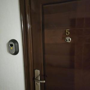 a wooden door with the number six on it at Apartament M2 Vatra Dornei in Vatra Dornei