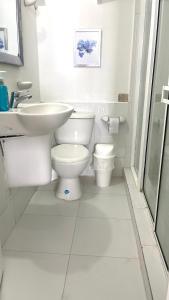 a white bathroom with a sink and a toilet at Espectacular Apartamento con Vista al Mar in San Andrés