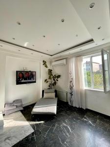 a living room with a couch and a window at dream villa in Tbilisi City