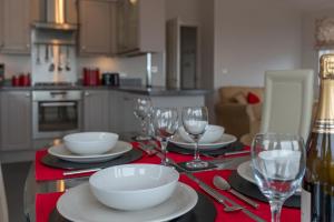 a table with plates and wine glasses on it at 46 Meadow View in Woolacombe