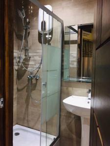 a bathroom with a shower and a sink at Royal Riverside Lodge in Big Ada