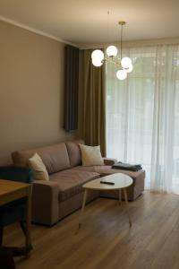 a living room with a couch and a table at Apartament Sand & Sun in Sianozety