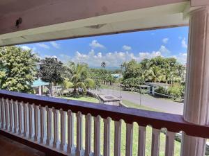 a balcony with a view of a park at Mountain View Family Home In Town With King Suite in San Ignacio