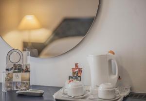 a bathroom counter with a mirror and a sink at Hotel Domus in Marina di Massa